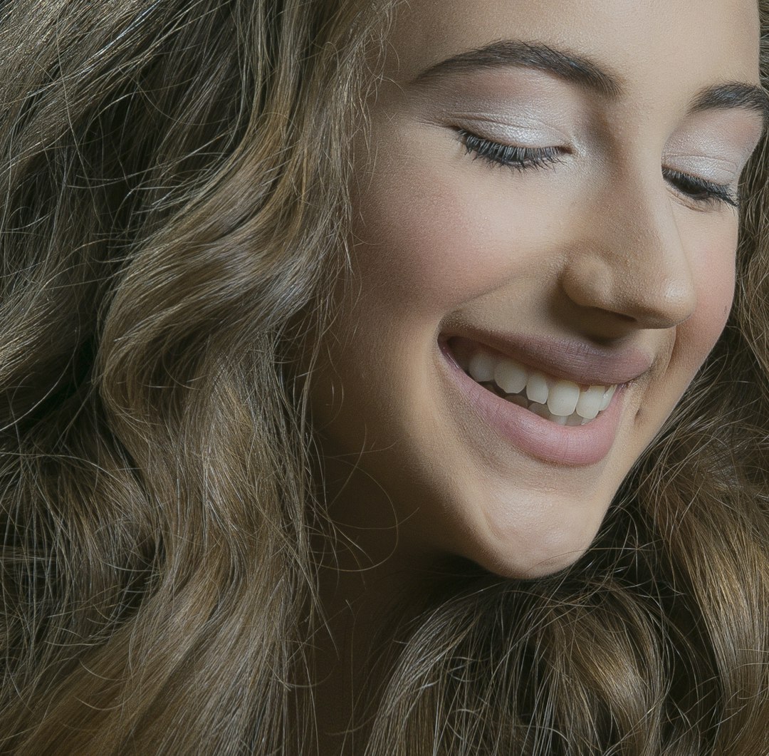 Portrait of smiling young professional woman with curly hair