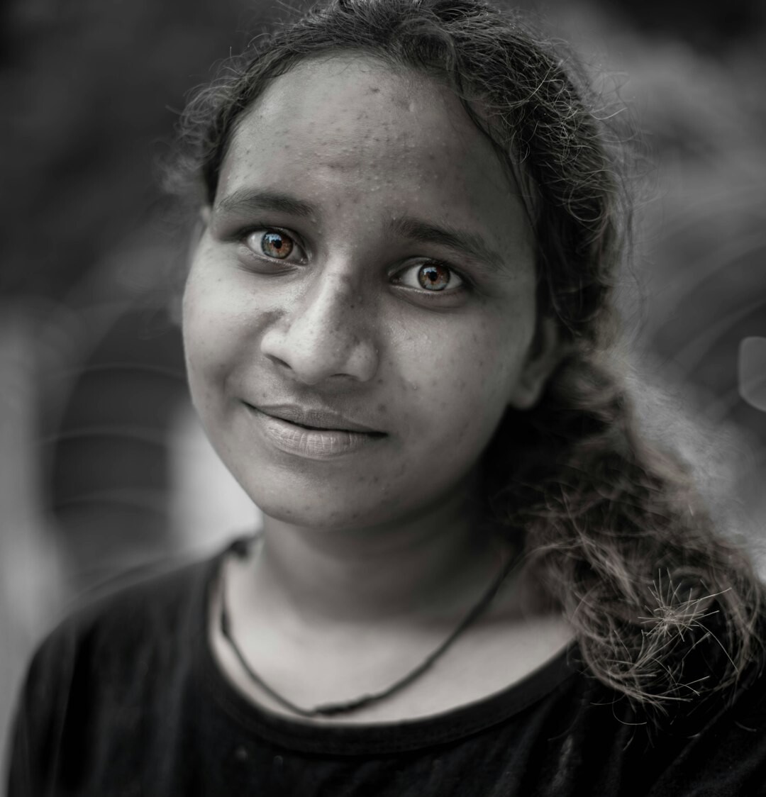 Professional portrait of a smiling young woman with dark hair
